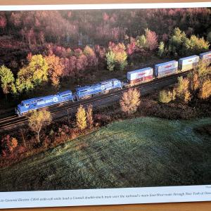 Promotional photo: Twin General Electric C40-8 wide-cab units lead a Conrail double-stack train over the railroad's main East-West route through New York at Oneida.