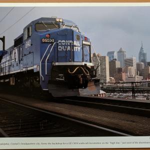 Promotional photo: Philadelphia, Conrail's headquarters city, forms the backdrop for a GE C40-8 wide-cab locomotive on the 'high line,' just west of the downtown area.