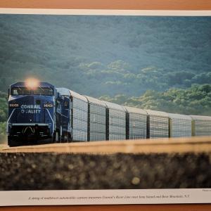 Promotional photo: A string of multilevel automobile carriers traverses Conrail's River Line near Iona Island and Bear Mountain, N.Y.