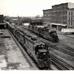 Photograph of SD45 6180, an unknown SD45 and GP38-2 8127 leading train JM-4 at Binghamton NY. SD45 8112, GP38 7956 and an unknown U23B are shown in the background. 9/26/76