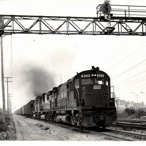Photograph of C628 6302 and other Alco Centuries on an eastbound grain train out of Cleveland OH. 7/31/76