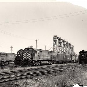 Damaged photograph of C628 641, GP38-2 8060, C628 639, F7 1745, GP40 3207 and others at Collinwood Engine Terminal. 8/28/76