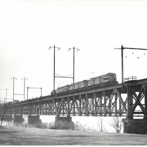 Photograph of GG1 4861 with two more units on the Susquehanna River Bridge in Perryville, MD. 2/19/77