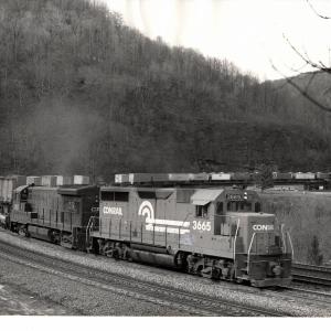 Photograph of GP35 3665 and U33B 2927 on a TV train at Horseshoe Curve. 3/8/77