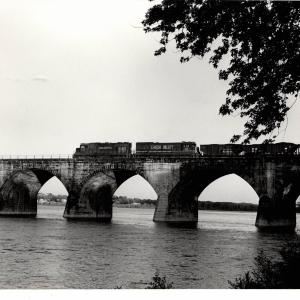 Photograph of GP38 7734 and U23B 510 crossing Rockville Bridge from the Marysville shore. 4/25/76