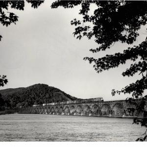 Photograph of SDP45 and two more units crossing Rockville Bridge westbound with a train off of the Buffalo Line. 5/76