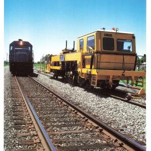 Promotional photo: An SD40-2 passes a continuous action tamper (CAT), used for compacting ballast under railroad ties. Conrail was the first U.S. railroad to use CAT equipment, which increases maintenance productivity.