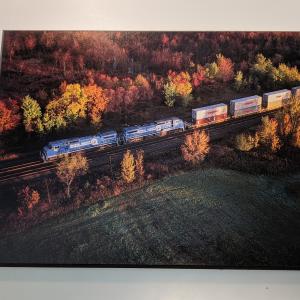 Wood Laminated Promotional photo: Twin General Electric C40-8 wide-cab units lead a Conrail double-stack train over the railroad's main East-West route through New York at Oneida.