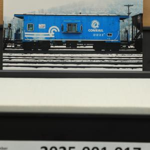 Color photo of N-21 caboose #21222 in Quality paint scheme with logo