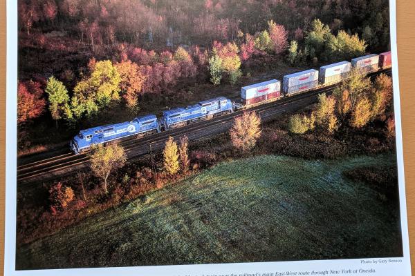 Promotional photo: Twin General Electric C40-8 wide-cab units lead a Conrail double-stack train over the railroad's main East-West route through New York at Oneida.