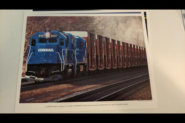 Promotional photo: A GP40 leads a string of recently refurbished auto-parts boxcars destined for an auto assembly plant.