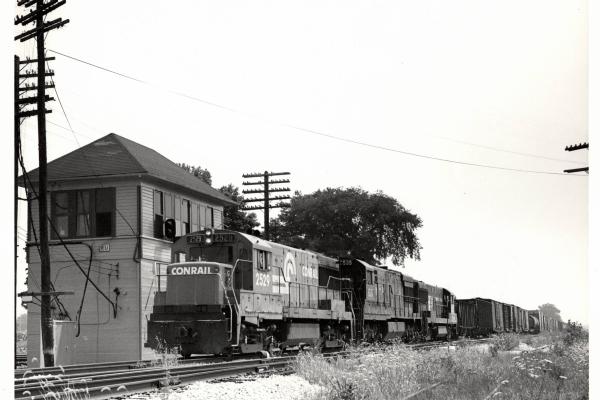 Photograph of U25B 2529 and two more units on train MC97 at RU Tower in Sterling OH. 7/24/77