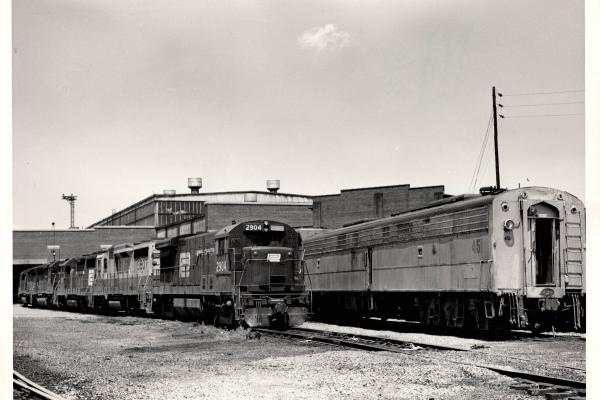 Photograph of U30B 2904, GP30 3607 and other locomotives at the Harrisburg Engine Shops. 7/76