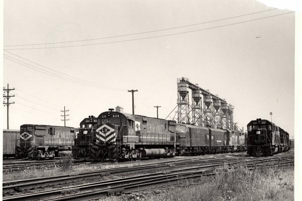 Damaged photograph of C628 641, GP38-2 8060, C628 639, F7 1745, GP40 3207 and others at Collinwood Engine Terminal. 8/28/76