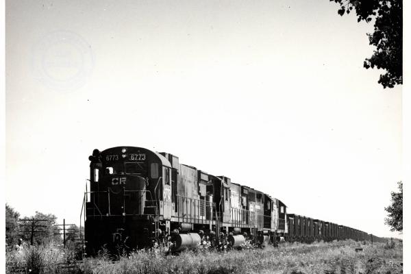 Photograph of C630 6773, C630 6754 and two more units on an empty ore train at Alliance OH. 7/22/77