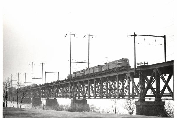 Photograph of GG1 4861 with two more units on the Susquehanna River Bridge in Perryville, MD. 2/19/77