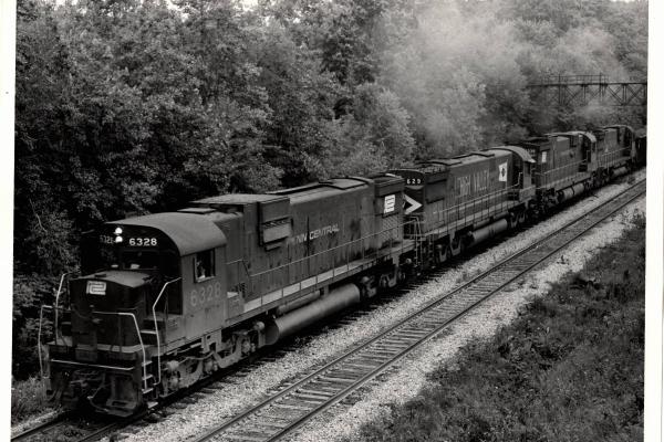 Photograph of C630 6328, C628 629 and C630 6338 on an ore train at Ravenna OH. 7/30/76