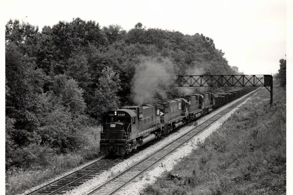 Photograph of C630 6328, C628 629 and C630 6338 on an ore train at Ravenna OH. 7/30/76