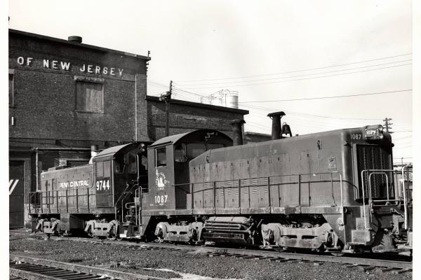Photograph of SW9 1087 and S4 9744 at E Port Shops. 12/6/76