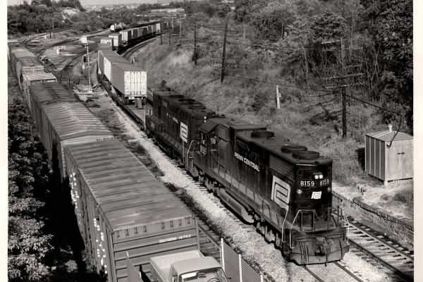 Photograph of GP38-2 8159 and GP9B 3801 on a detouring TV train at the B&O Mt Winans Yard in Baltimore. 9/19/76