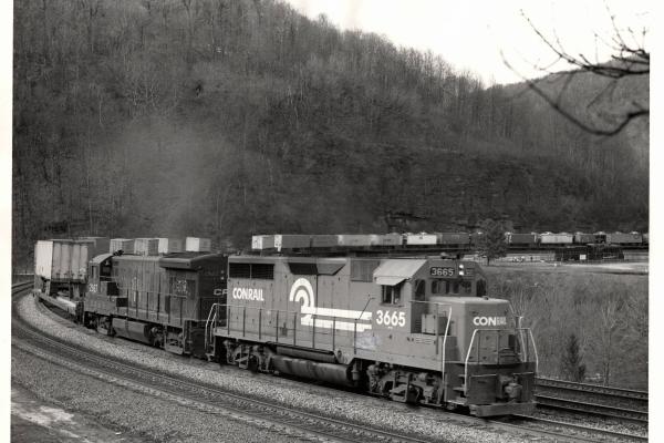 Photograph of GP35 3665 and U33B 2927 on a TV train at Horseshoe Curve. 3/8/77