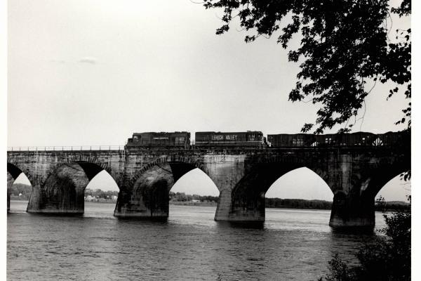 Photograph of GP38 7734 and U23B 510 crossing Rockville Bridge from the Marysville shore. 4/25/76