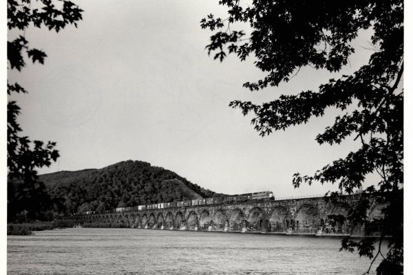 Photograph of SDP45 and two more units crossing Rockville Bridge westbound with a train off of the Buffalo Line. 5/76