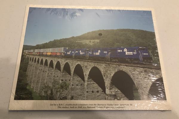 Promotional photo: Led by a B36-7, double-stack containers cross the Starrucca Viaduct near Lanesboro, Pa. The viaduct, built in 1848, is a National Historic Engineering Landmark. (shrink wrapped packet)