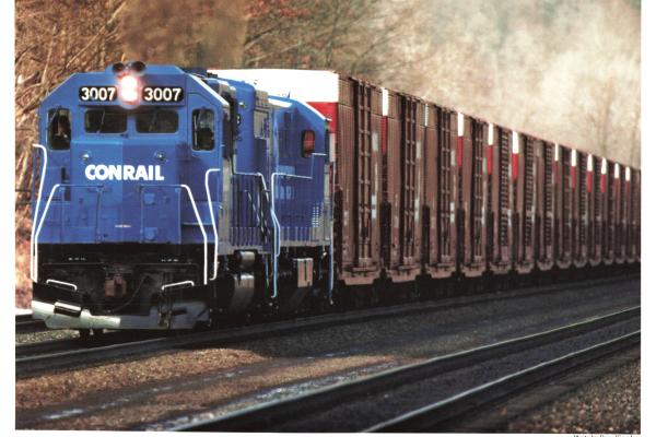 Promotional photo: A GP40 leads a string of recently refurbished auto-parts boxcars destined for an auto assembly plant.