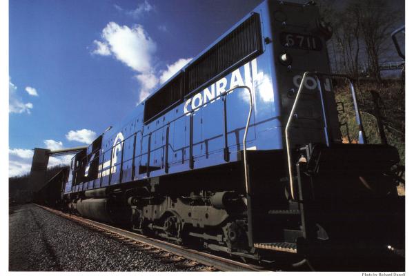 Promotional photo: An SD50 pulls a unit coal train past the loading tipple at High Power Mountain, a low-sulfur coal mine near Drennen, W. Va.