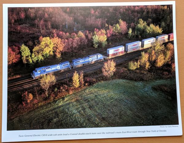 Promotional photo: Twin General Electric C40-8 wide-cab units lead a Conrail double-stack train over the railroad's main East-West route through New York at Oneida.