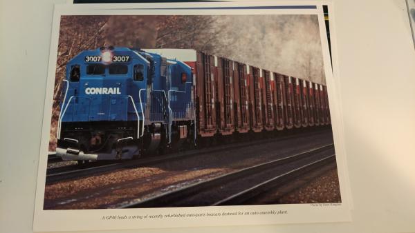 Promotional photo: A GP40 leads a string of recently refurbished auto-parts boxcars destined for an auto assembly plant.