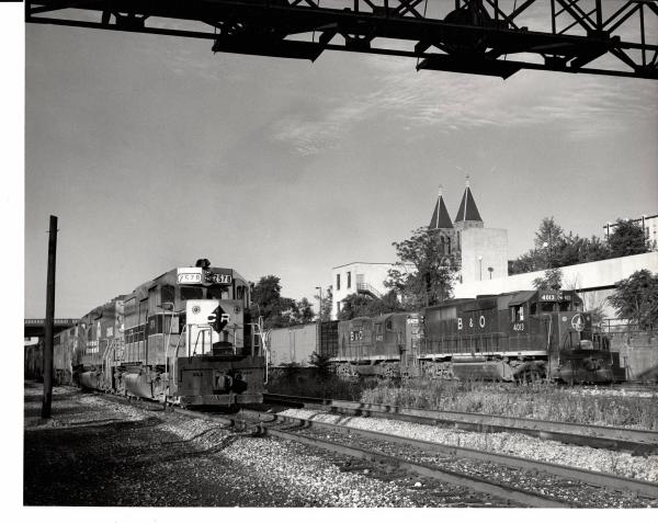 Photograph of GP35 7578 on B&O tracks meeting a detouring B&O on Conrail tracks train at Akron OH. 7/23/77.