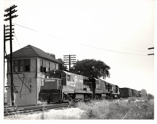 Photograph of U25B 2529 and two more units on train MC97 at RU Tower in Sterling OH. 7/24/77