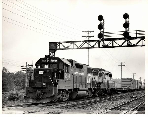 Photograph of GP38-2 7949 and GP30 2177 eastbound out of Cleveland. 7/31/76