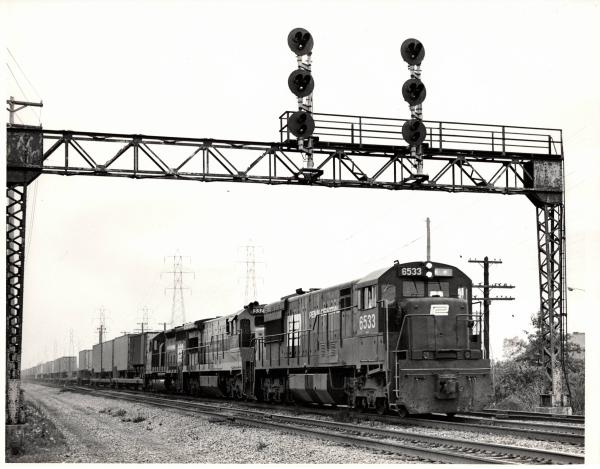 Photograph of U28C 6533 U36C 3323 and an unknown SD40 in Cleveland OH. 7/76
