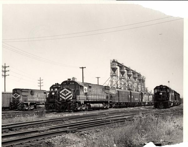 Damaged photograph of C628 641, GP38-2 8060, C628 639, F7 1745, GP40 3207 and others at Collinwood Engine Terminal. 8/28/76