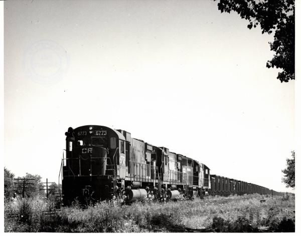 Photograph of C630 6773, C630 6754 and two more units on an empty ore train at Alliance OH. 7/22/77