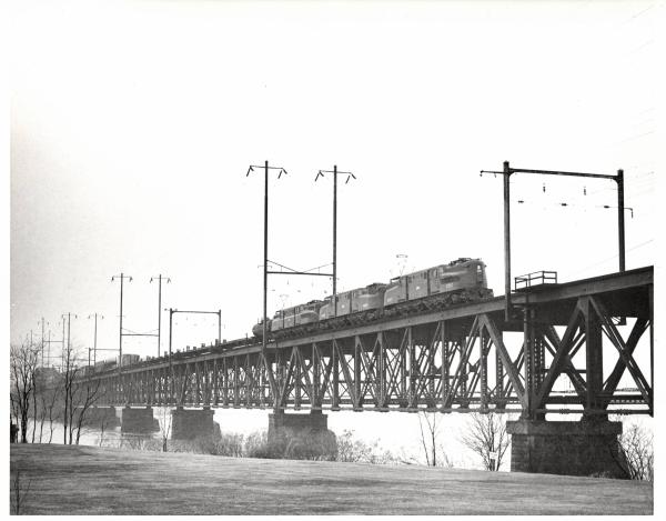 Photograph of GG1 4861 with two more units on the Susquehanna River Bridge in Perryville, MD. 2/19/77
