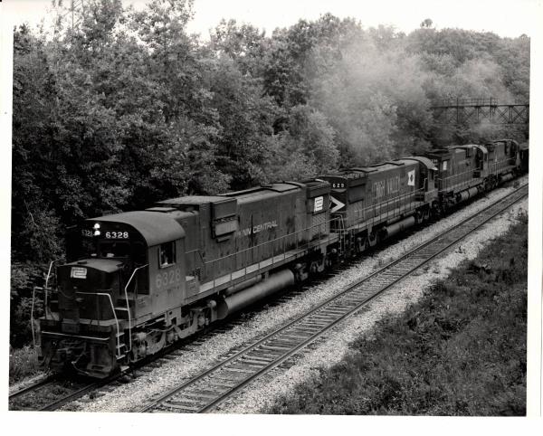 Photograph of C630 6328, C628 629 and C630 6338 on an ore train at Ravenna OH. 7/30/76