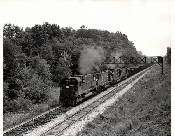 Photograph of C630 6328, C628 629 and C630 6338 on an ore train at Ravenna OH. 7/30/76