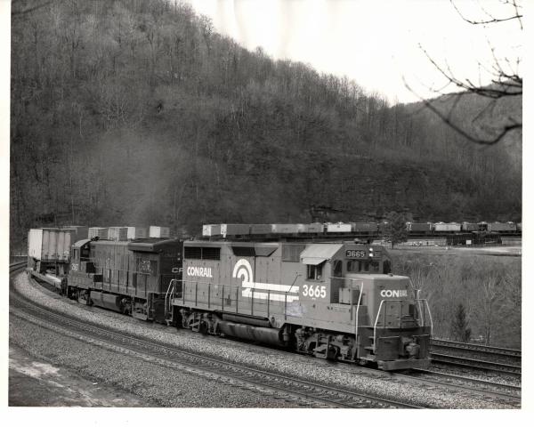 Photograph of GP35 3665 and U33B 2927 on a TV train at Horseshoe Curve. 3/8/77