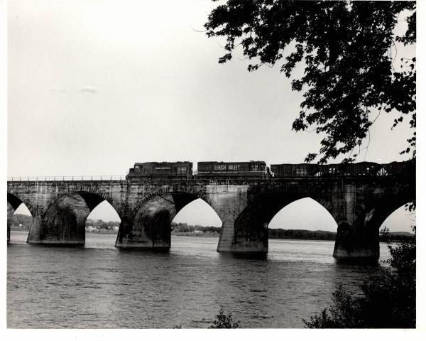 Photograph of GP38 7734 and U23B 510 crossing Rockville Bridge from the Marysville shore. 4/25/76