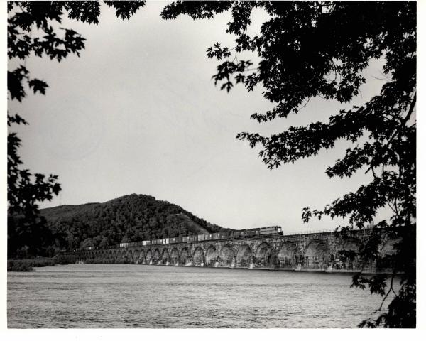 Photograph of SDP45 and two more units crossing Rockville Bridge westbound with a train off of the Buffalo Line. 5/76