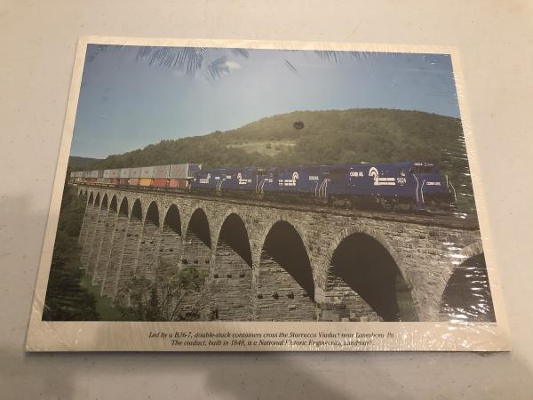 Promotional photo: Led by a B36-7, double-stack containers cross the Starrucca Viaduct near Lanesboro, Pa. The viaduct, built in 1848, is a National Historic Engineering Landmark. (shrink wrapped packet)