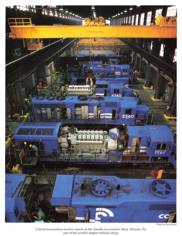 Promotional photo: Conrail locomotives receive repairs at the Juniata Locomotive Shop, Altoona PA., one of the world's largest railroad shops.