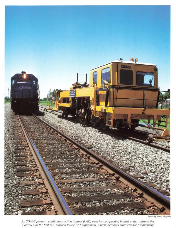 Promotional photo: An SD40-2 passes a continuous action tamper (CAT), used for compacting ballast under railroad ties. Conrail was the first U.S. railroad to use CAT equipment, which increases maintenance productivity.