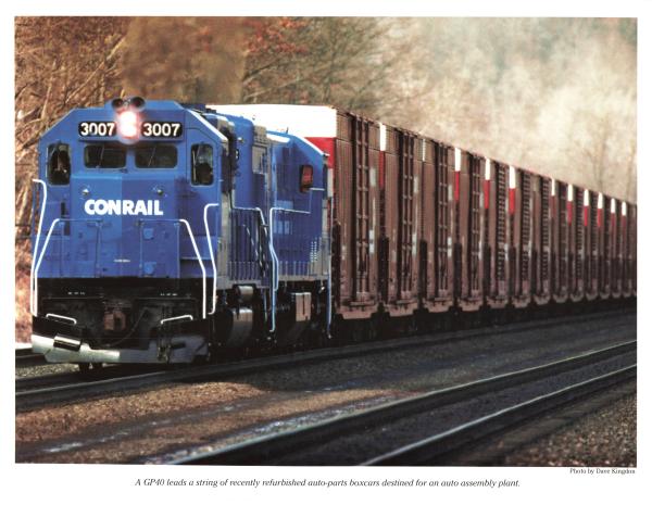 Promotional photo: A GP40 leads a string of recently refurbished auto-parts boxcars destined for an auto assembly plant.