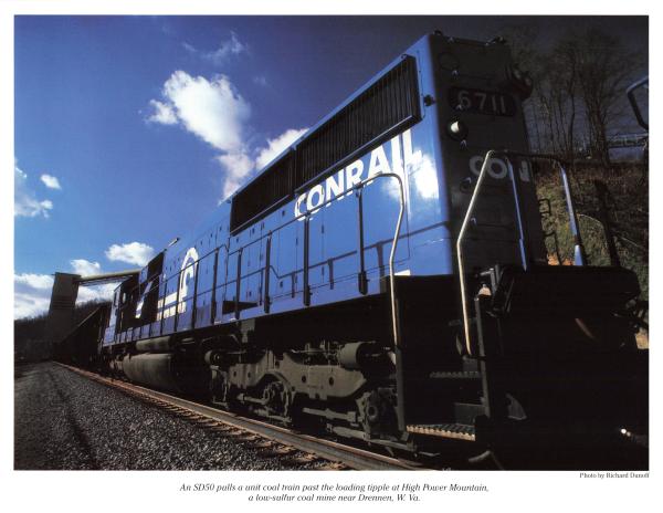 Promotional photo: An SD50 pulls a unit coal train past the loading tipple at High Power Mountain, a low-sulfur coal mine near Drennen, W. Va.