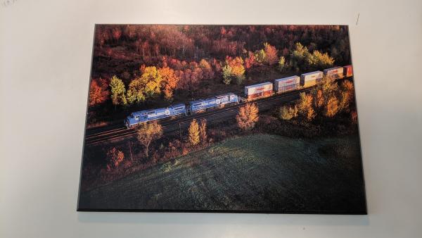 Wood Laminated Promotional photo: Twin General Electric C40-8 wide-cab units lead a Conrail double-stack train over the railroad's main East-West route through New York at Oneida.